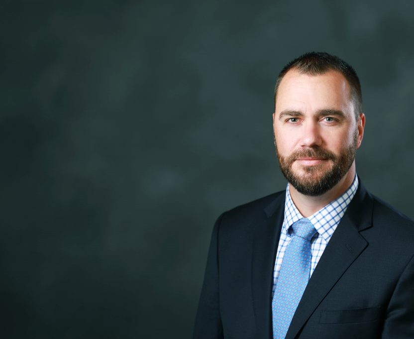 Ryan Cleckner headshot in a suit Ryan Cleckner headshot in a suit